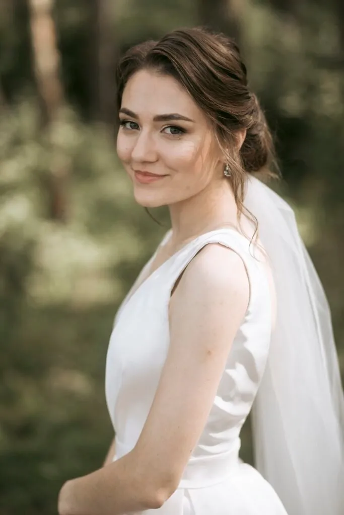 Soft romantic bridal makeup and elegant updo hairstyle by ABC Face in Chicago