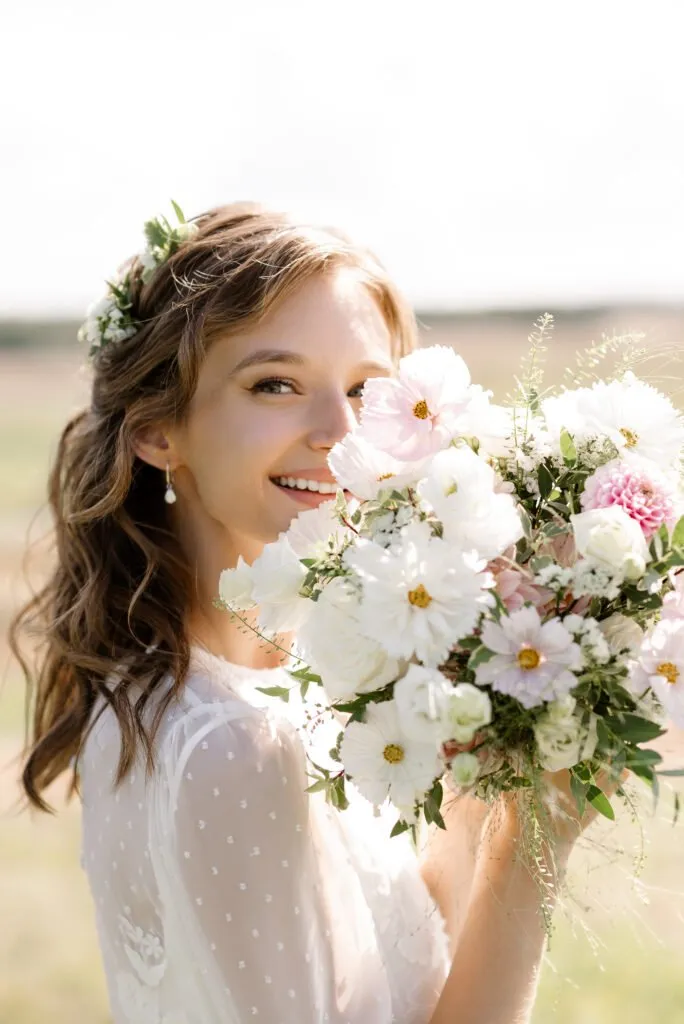 Boho chic bridal makeup and hairstyle with flowers in hair and natural waves by ABC Face in Chicago