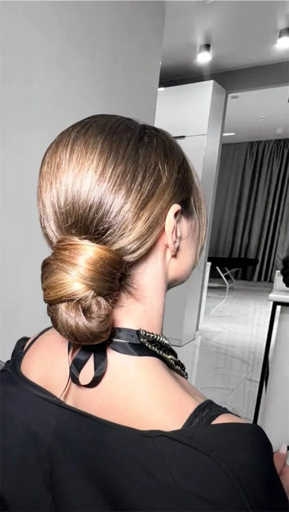 Sleek low bun hairstyle with smooth finish for weddings and evening events in Chicago