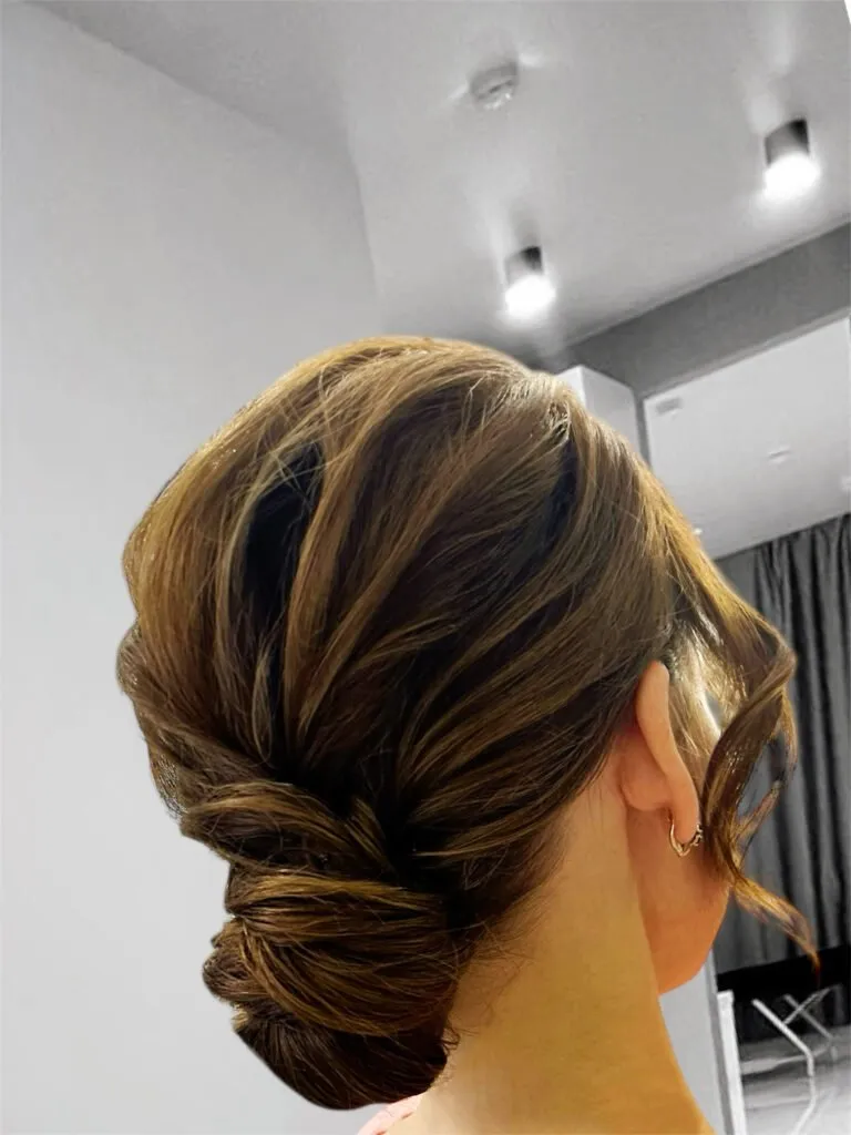 Elegant twisted low updo hairstyle with soft volume for weddings and evening events in Chicago