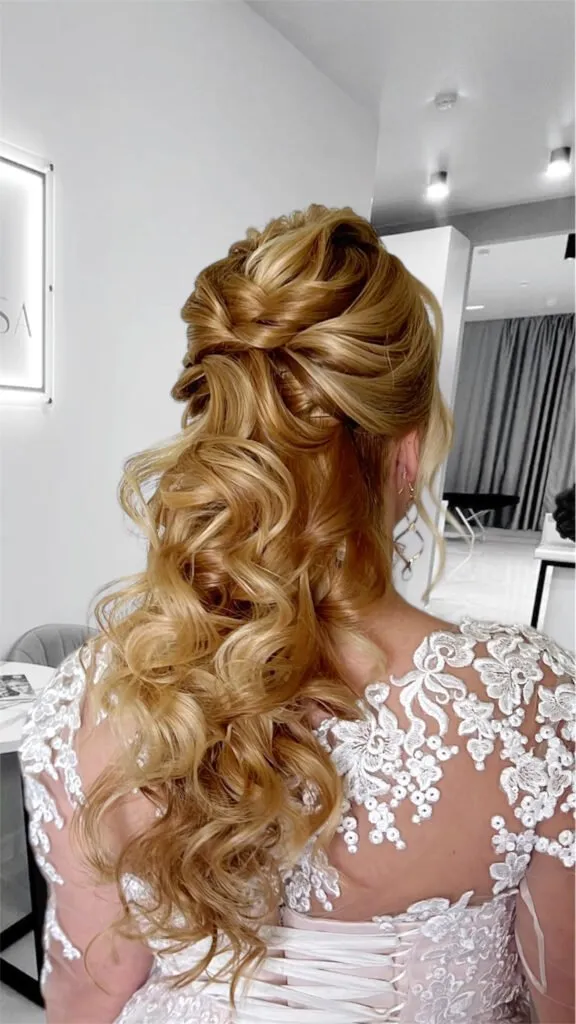 Romantic half-up bridal hairstyle with soft curls and braiding for weddings and events in Chicago