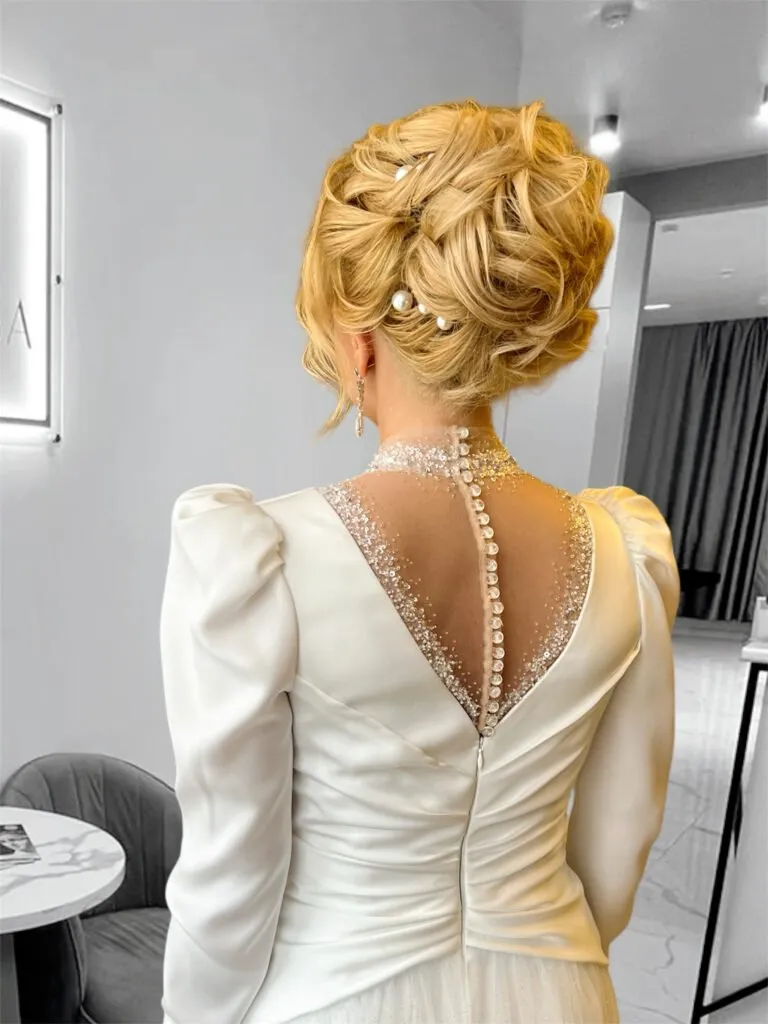 Elegant bridal updo with pearls and soft curls for weddings and events in Chicago