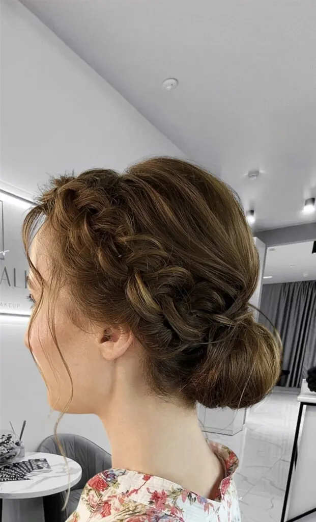 Braided low bun event hairstyle with soft texture and romantic elegance in Chicago