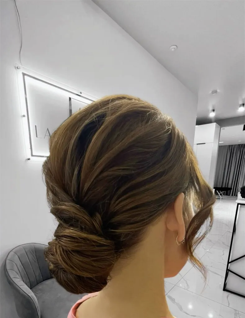 Classic low twist bun event hairstyle with sleek finish and elegant texture in Chicago
