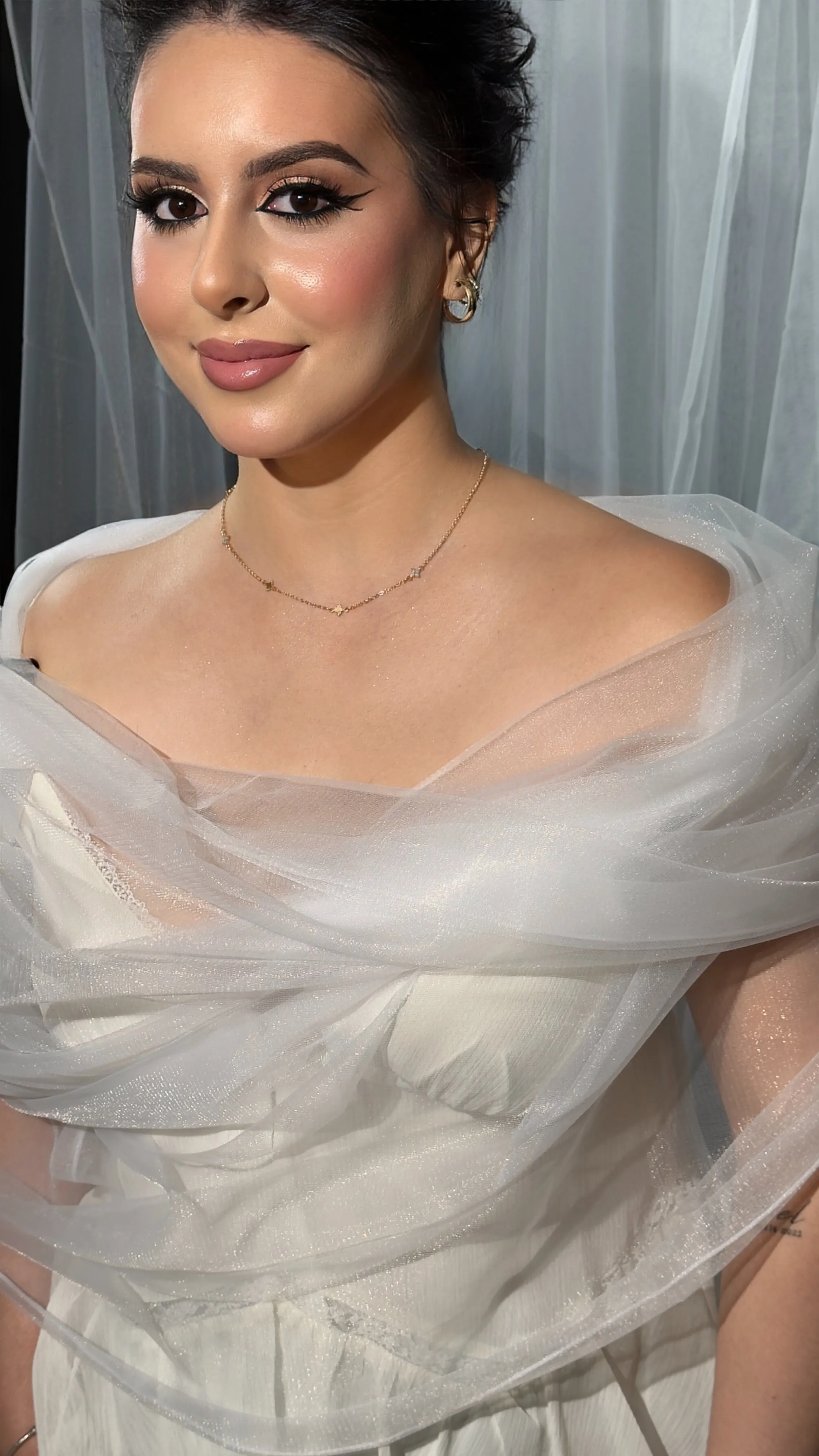 Glam bridal makeup with glowing skin, sharp wing and nude lip
