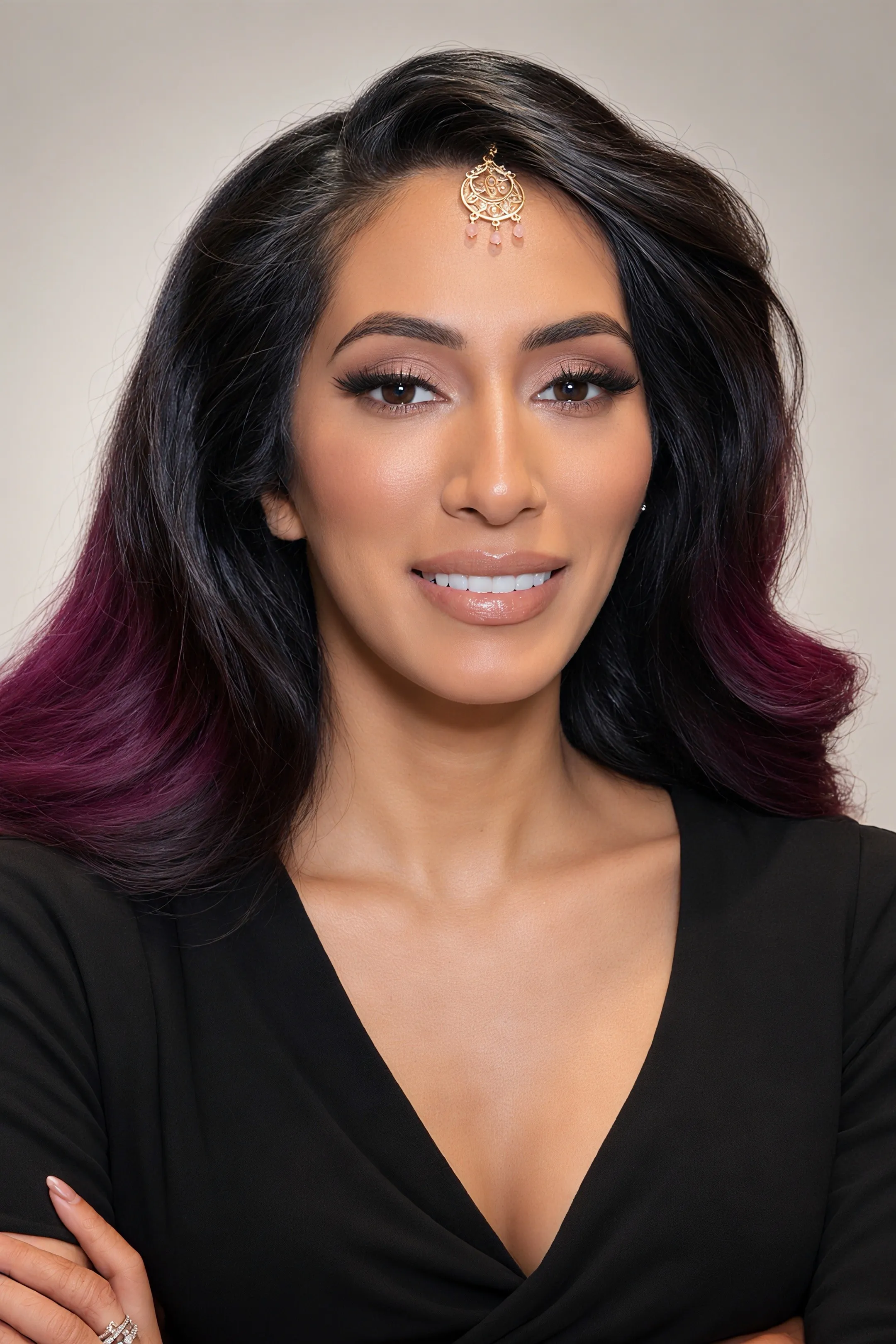 Close-up of soft glam event makeup with voluminous dark waves and plum accents