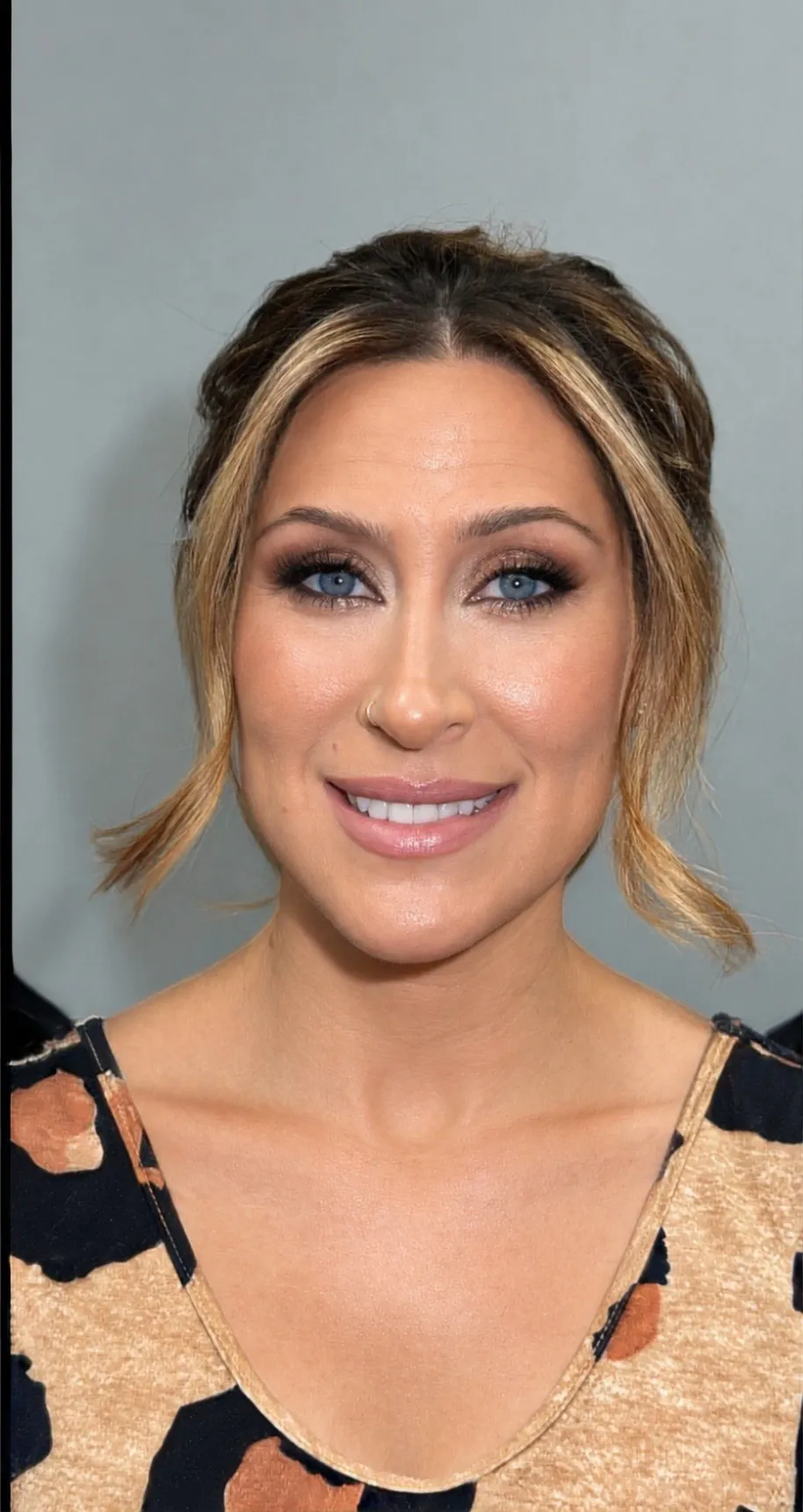 Soft glam event makeup with softly shaded eyes, lifted lashes, and a natural rose lip
